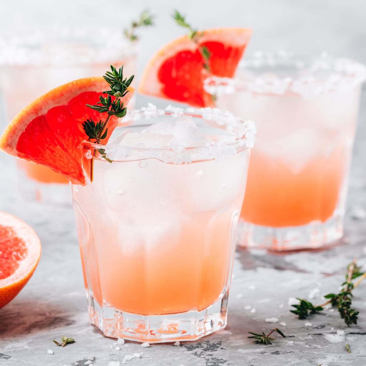 Refreshing Salty Dog Cocktail with Grapefruit Wedges, Ice, and Salt