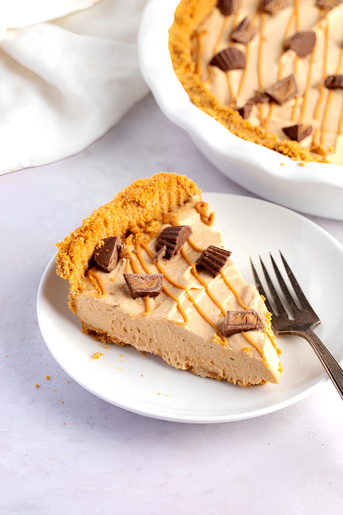 Sliced Homemade No-Bake Peanut Butter Pie in a Plate