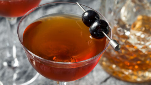 Top view of a glass of Rob Roy Cocktail garnished with cocktail cherries