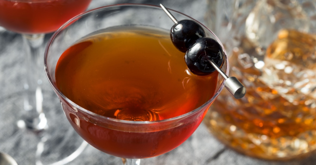 Top view of a glass of Rob Roy Cocktail garnished with cocktail cherries
