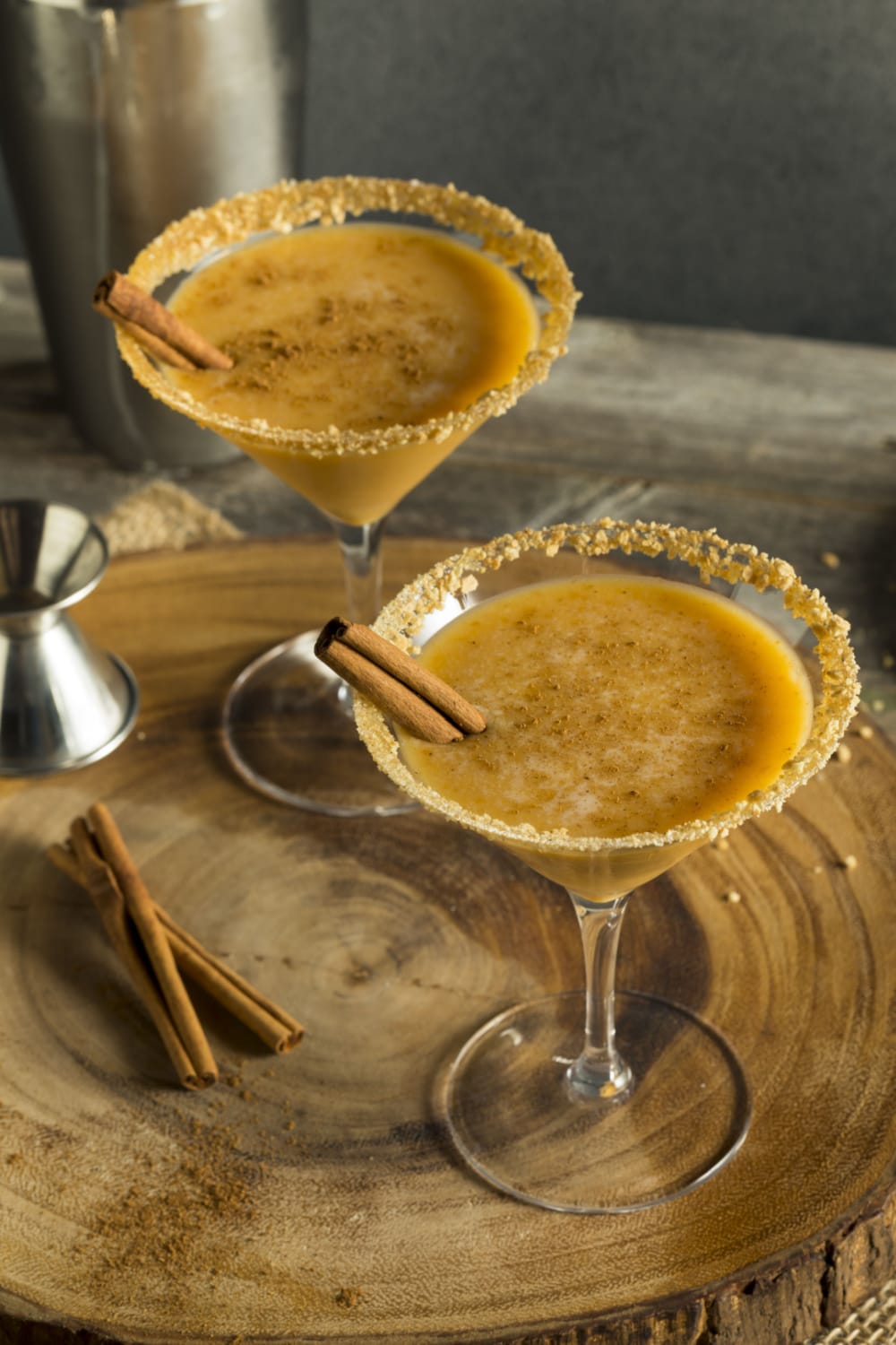 Two Glasses of Autumn Cocktail Pumpkin Martini on a Wooden Board