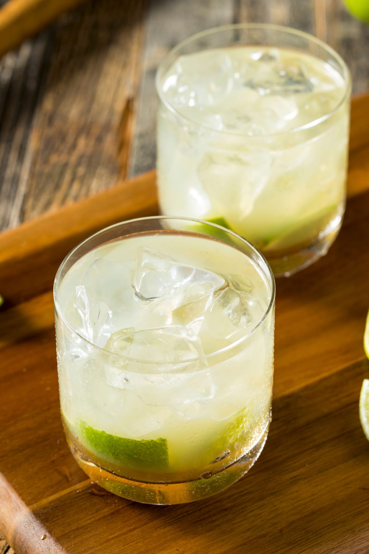 Caipirinha Cocktail Recipe- A Brazilian Drink featuring Refreshing Caipirinha Cocktail in Old-Fashioned Glasses on the Rocks with Lime