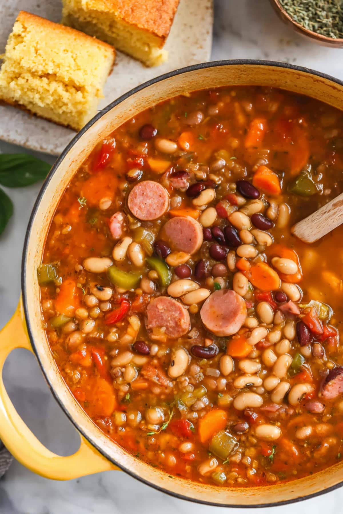 10-Bean soup with smoked ham, and ham hock in a large pot.