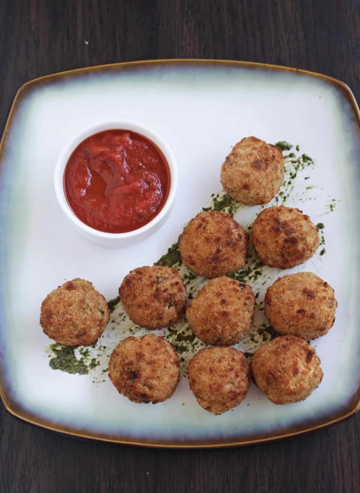 Homemade Air Fryer Arancini (Rice Balls) on a plate and a bowl of ketchup