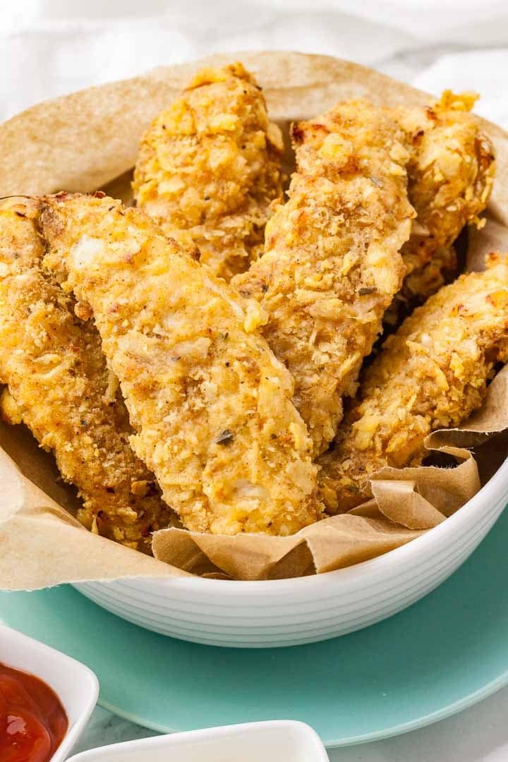 Homemade Air Fryer Chicken Tenders on a bowl with parchment paper