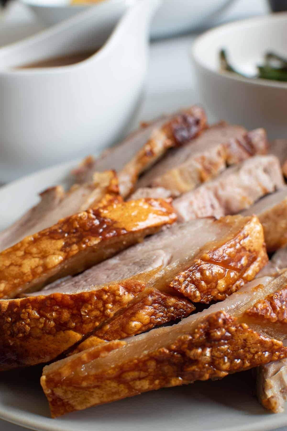 Slices of homemade Air Fryer Pork Roast with gravy on the side