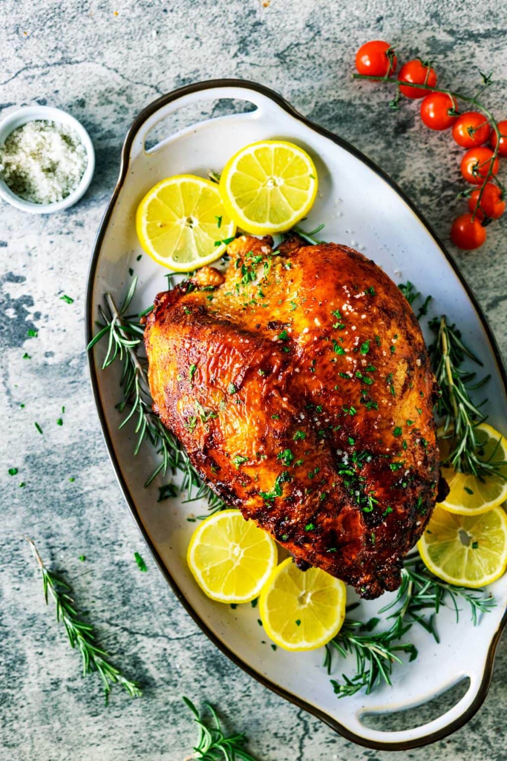 Air Fryer Turkey Breast garnished with rosemary and lemon wheels
