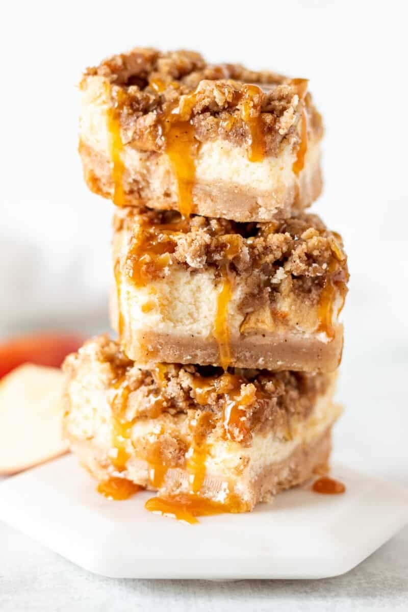 Stacked apple chai cheesecake bars in a plate. 