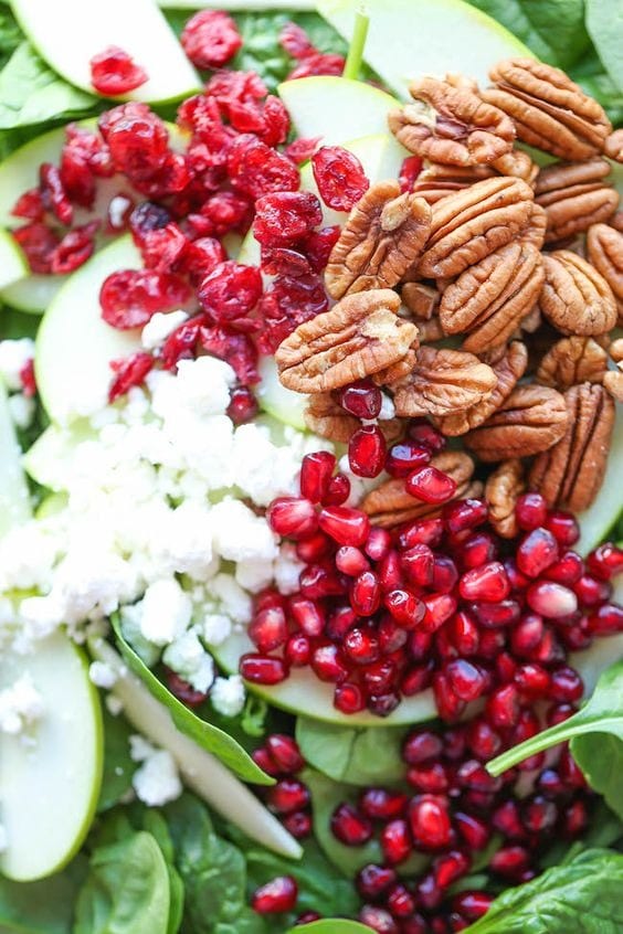 Apple cranberry pecan salad with chunks of crisp apple, nutty pecans, and bright pomegranate seeds. 