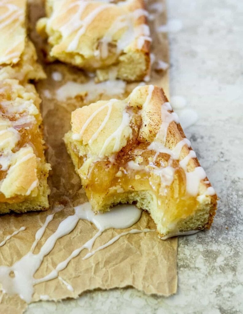 Sliced apple bars drizzled with sugar glaze. 