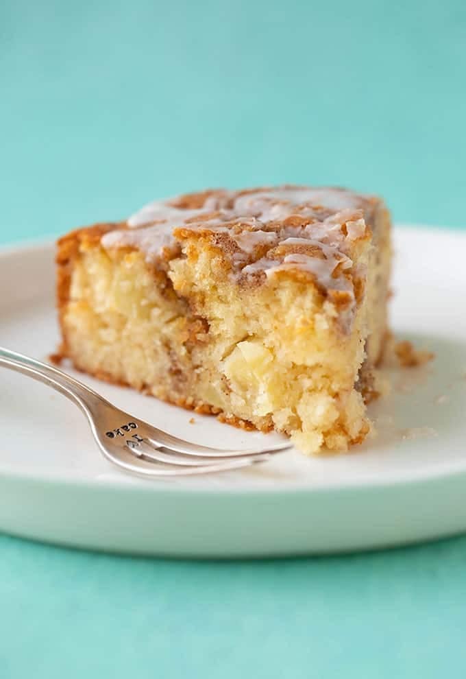 A slice of cinnamon apple cake in a plate. 