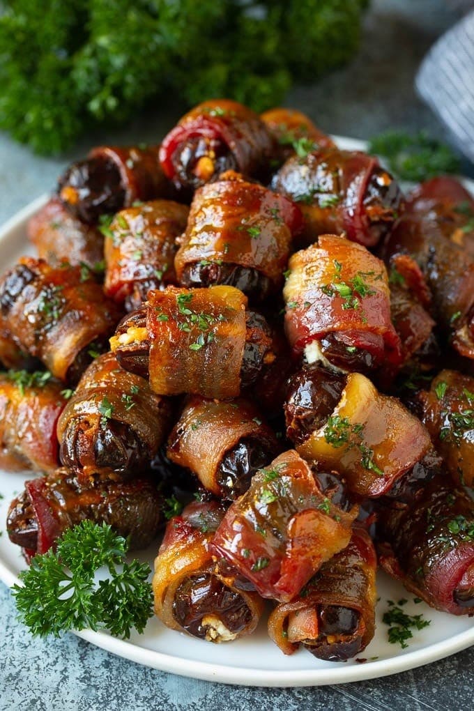 Plate full of glazing bacon wrapped dates. 