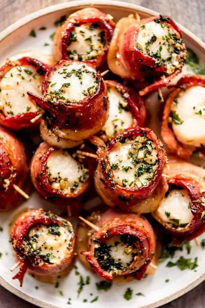 Bacon wrapped scallops served on a plate. 
