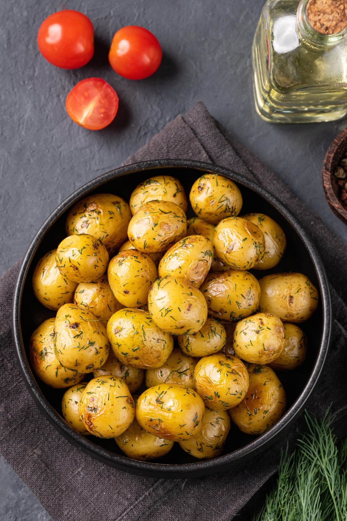 Baked Baby Potatoes with Herbs on a Gray Background