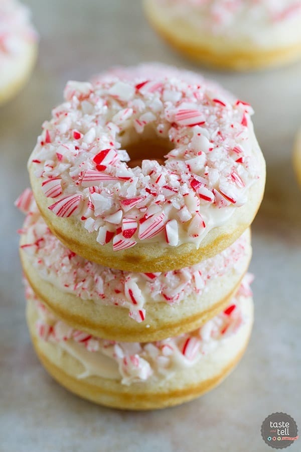 Stack of peppermint donuts with sprinkled of cracked sugar cane candy. 