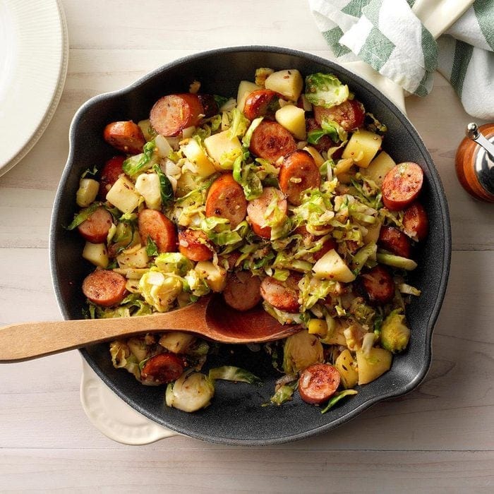 A skillet with brussels sprouts, potatoes, and sausage sizzling together, creating a delicious and hearty meal