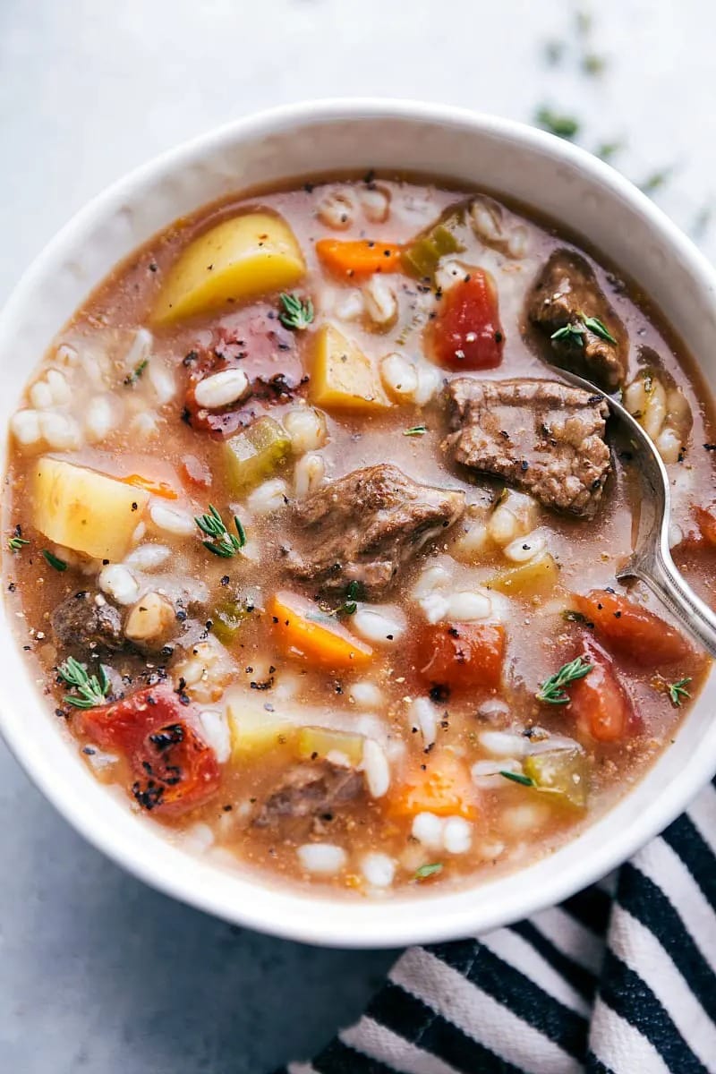 Closeup of a bowl with beef and barley soup.