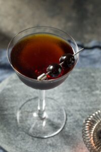 Boozy Black Manhattan Cocktail with Black Cherries