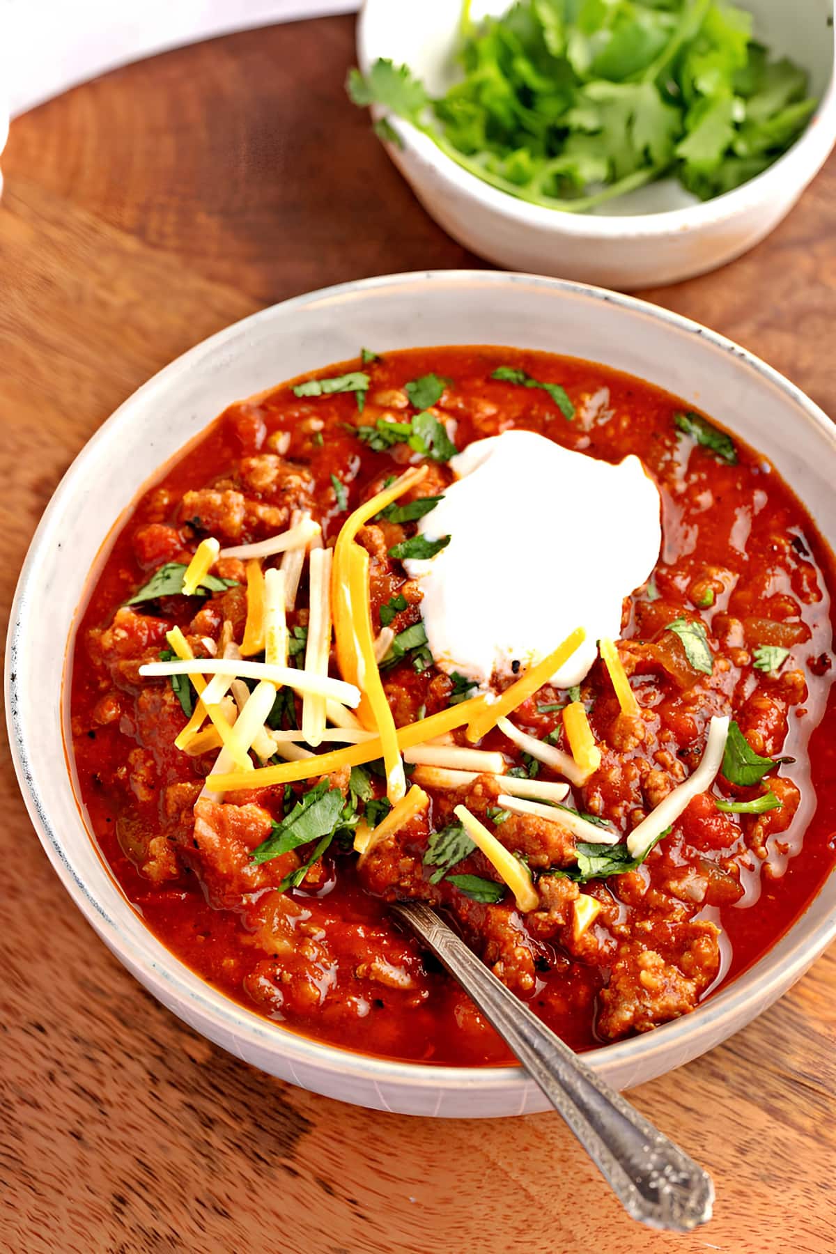 Bowl of Chipotle Chili Topped with Cilantro, Sour Cream and Cheese