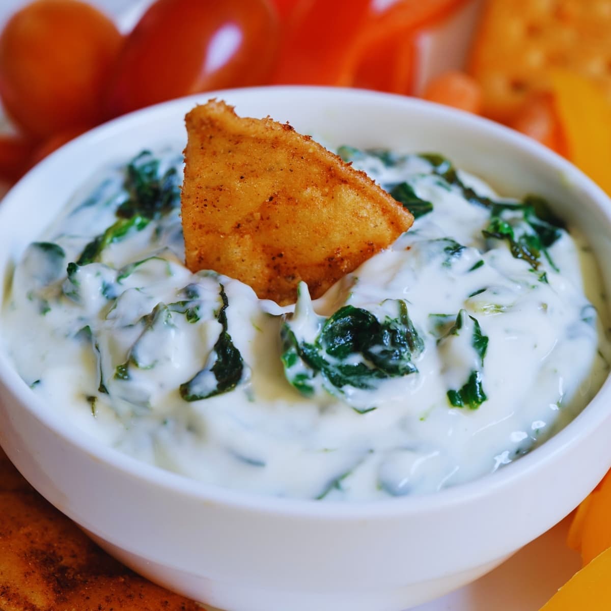 Cracker dipped on a bowl of Knorr Spinach Dip