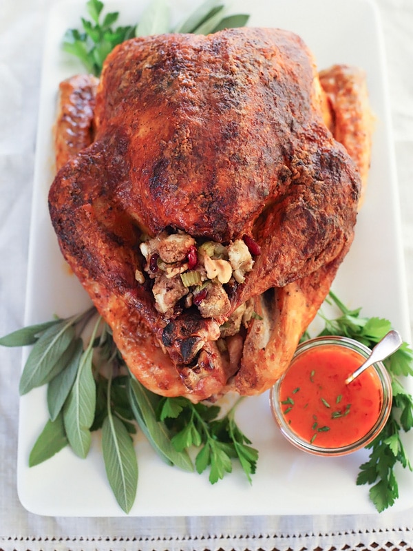 Buffalo Oven-Roasted Turkey with sauce and garnish with sage and parsley