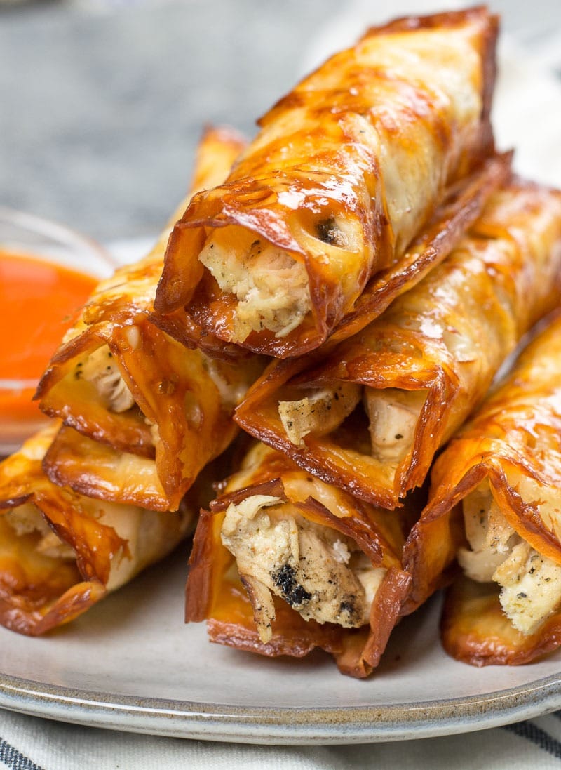 Stack of buffalo chicken taquitos in plate. 