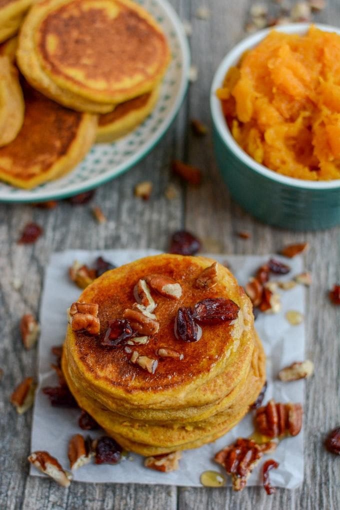 Butternut squash pancake drizzled with maple syrup and chopped pecan nuts on top. 