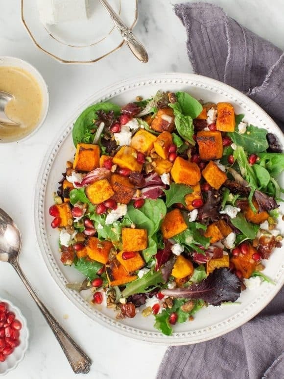 Roasted butternut squash salad with spiced squash, juicy pomegranate seeds, and tangy goat cheese.