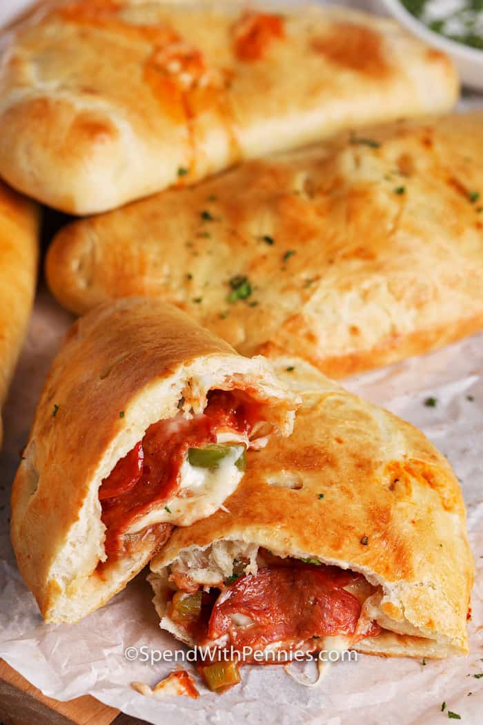 Calzone Stuffed with Pepperoni and Cheese on a Parchment Paper