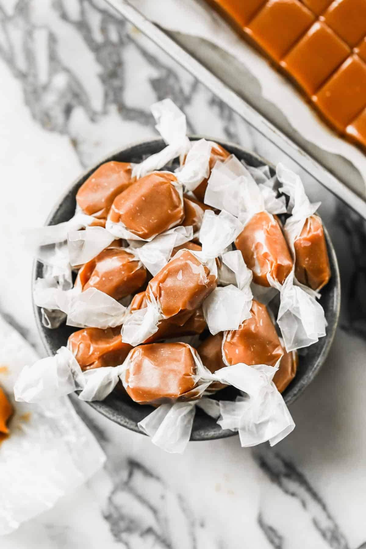 Bunch of Caramels on a bowl wrap in parchment paper