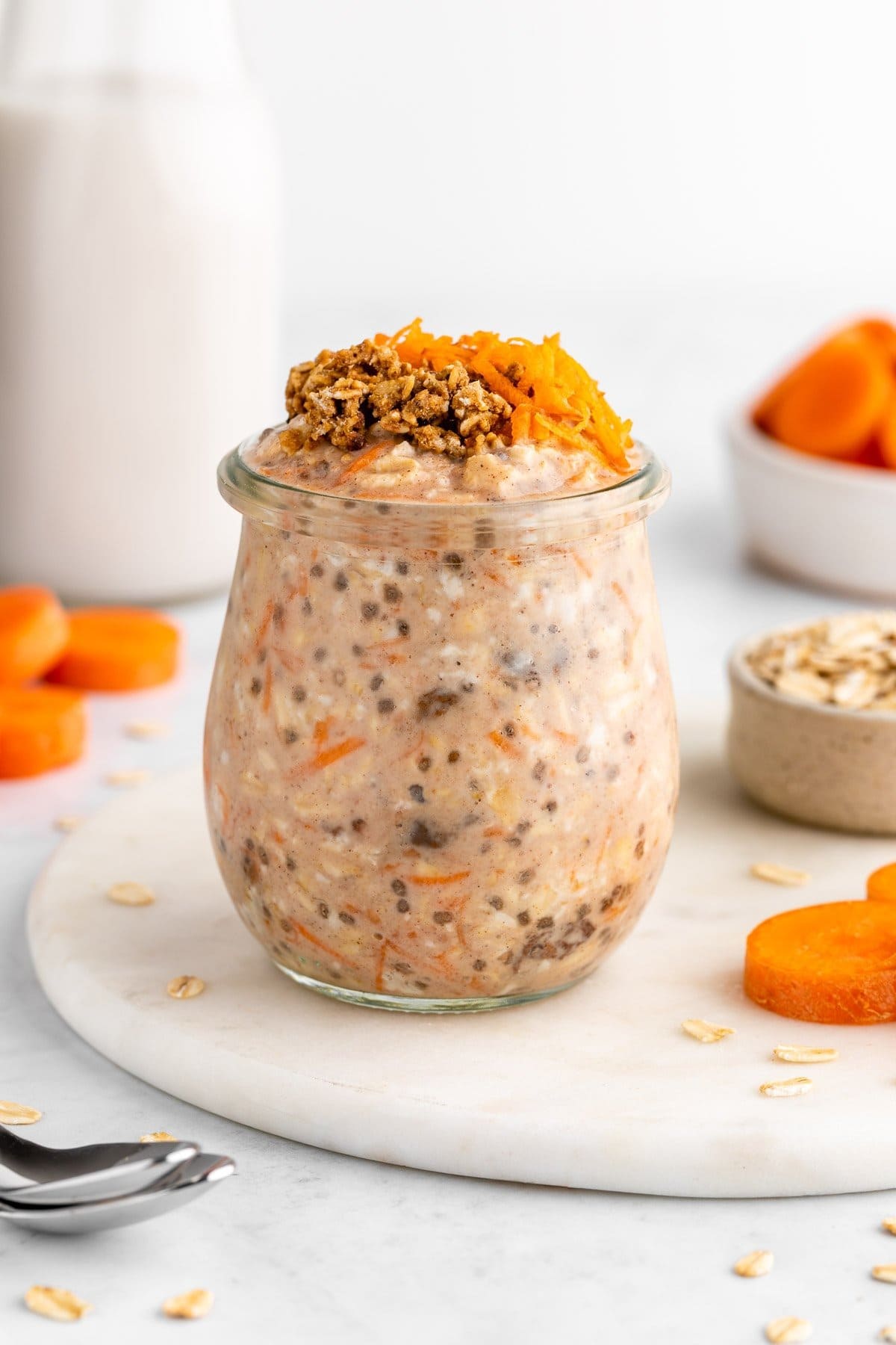 Jar of homemade Carrot Cake Overnight Oats with chia seed, raisins. rolled oats and grated carrots