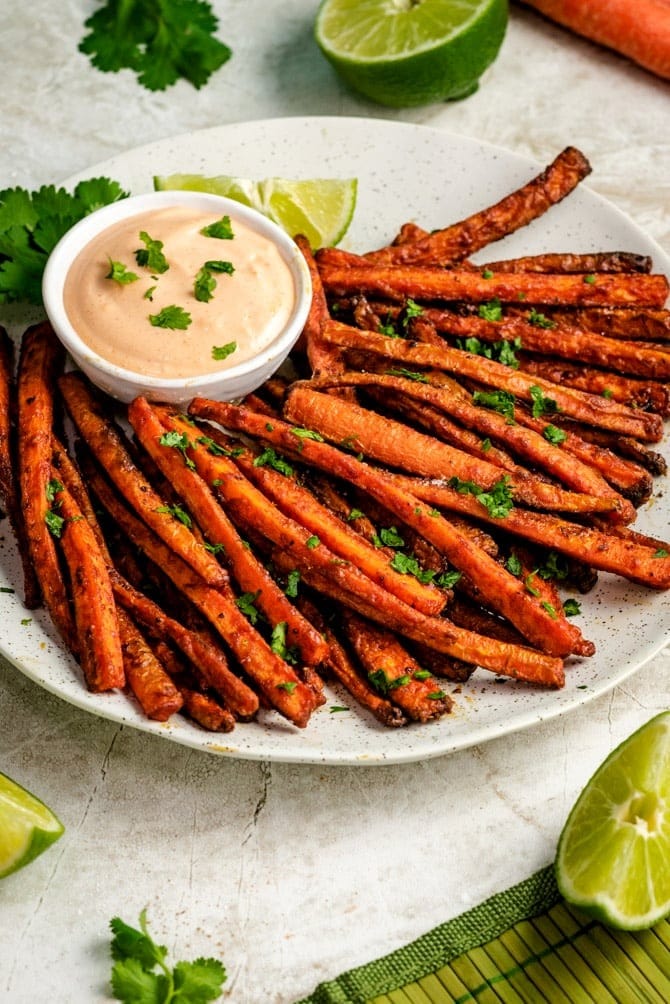Homemade Carrot Fries with dipping sauce   slice lime and garnish with chopped parsley