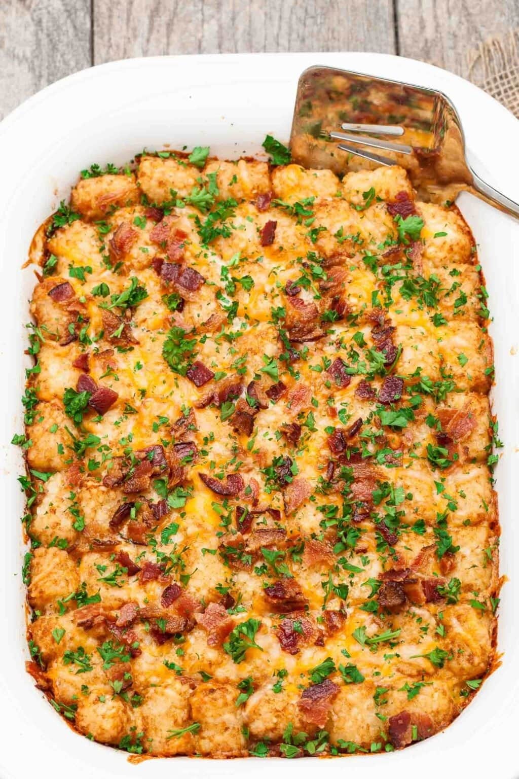 Cheesy Tater Tot Breakfast Casserole with bacon, eggs, sausage, and, of course, tater tots
