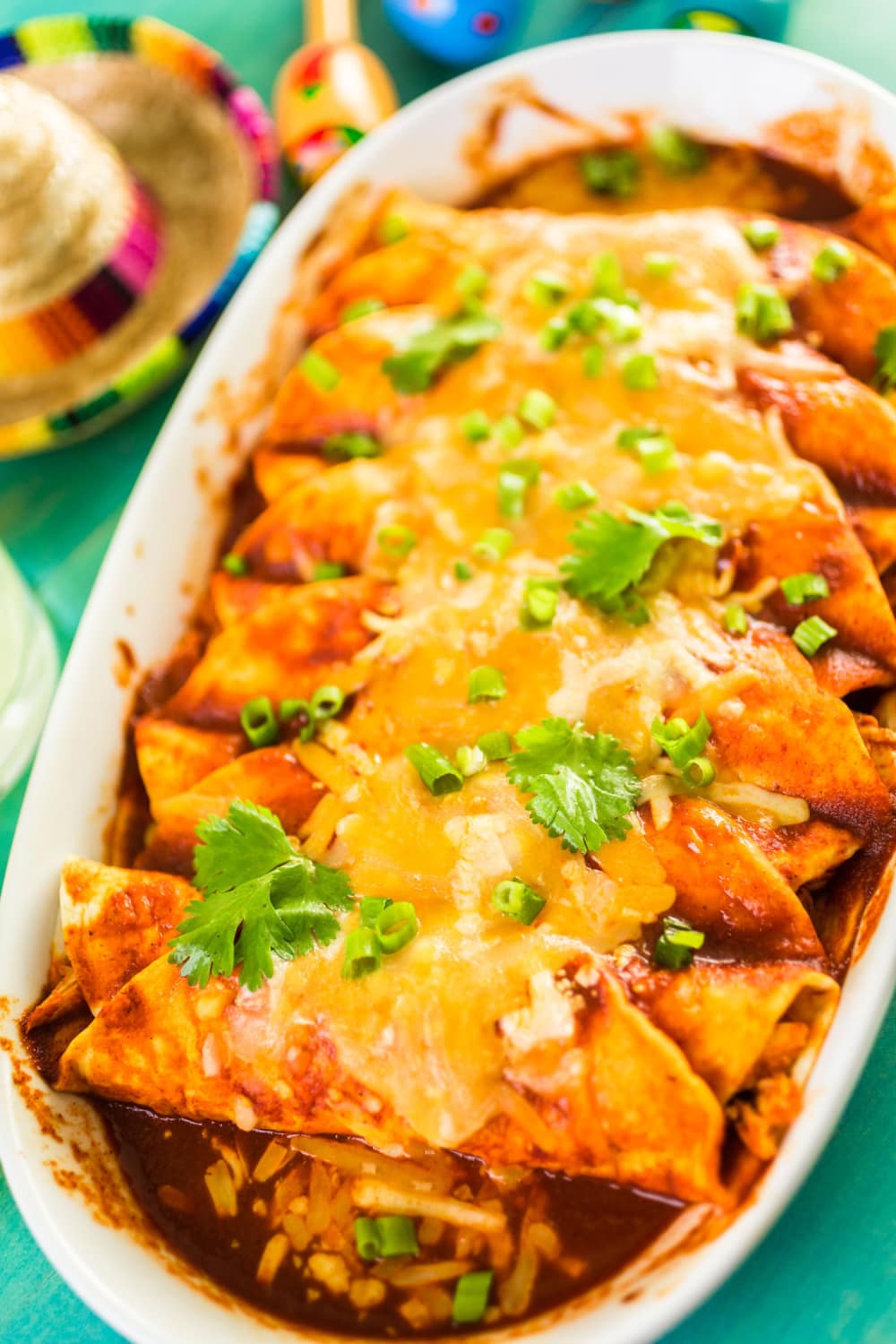 Chicken enchiladas with chopped cilantro leaves. 