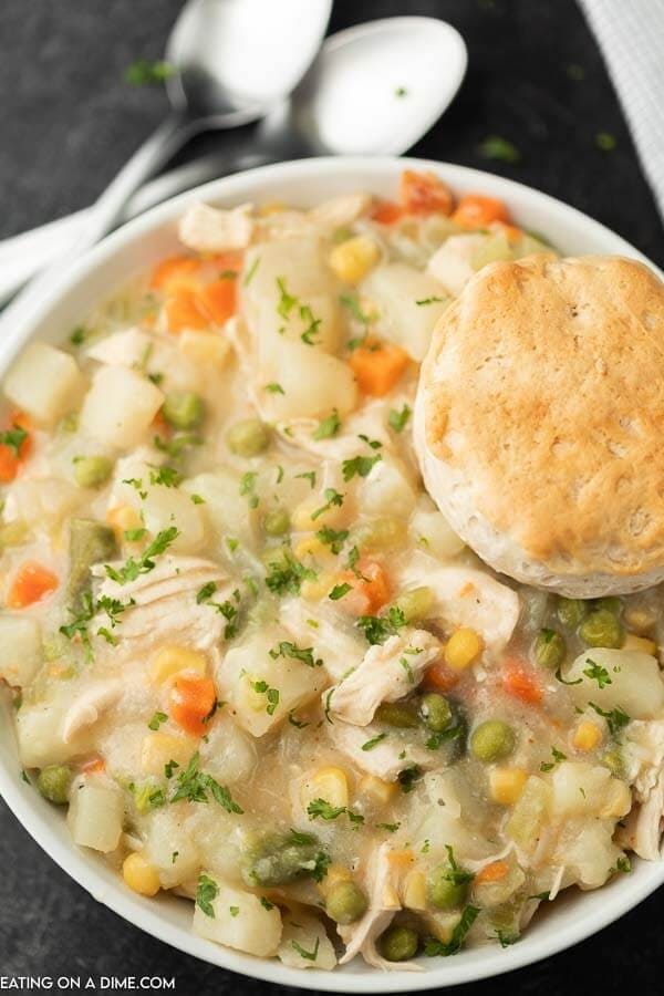 Bowl of homemade Chicken Pot Pie Crockpot Recipe with mix celery stalks, beans, carrots, green beans, green peas and potatoes