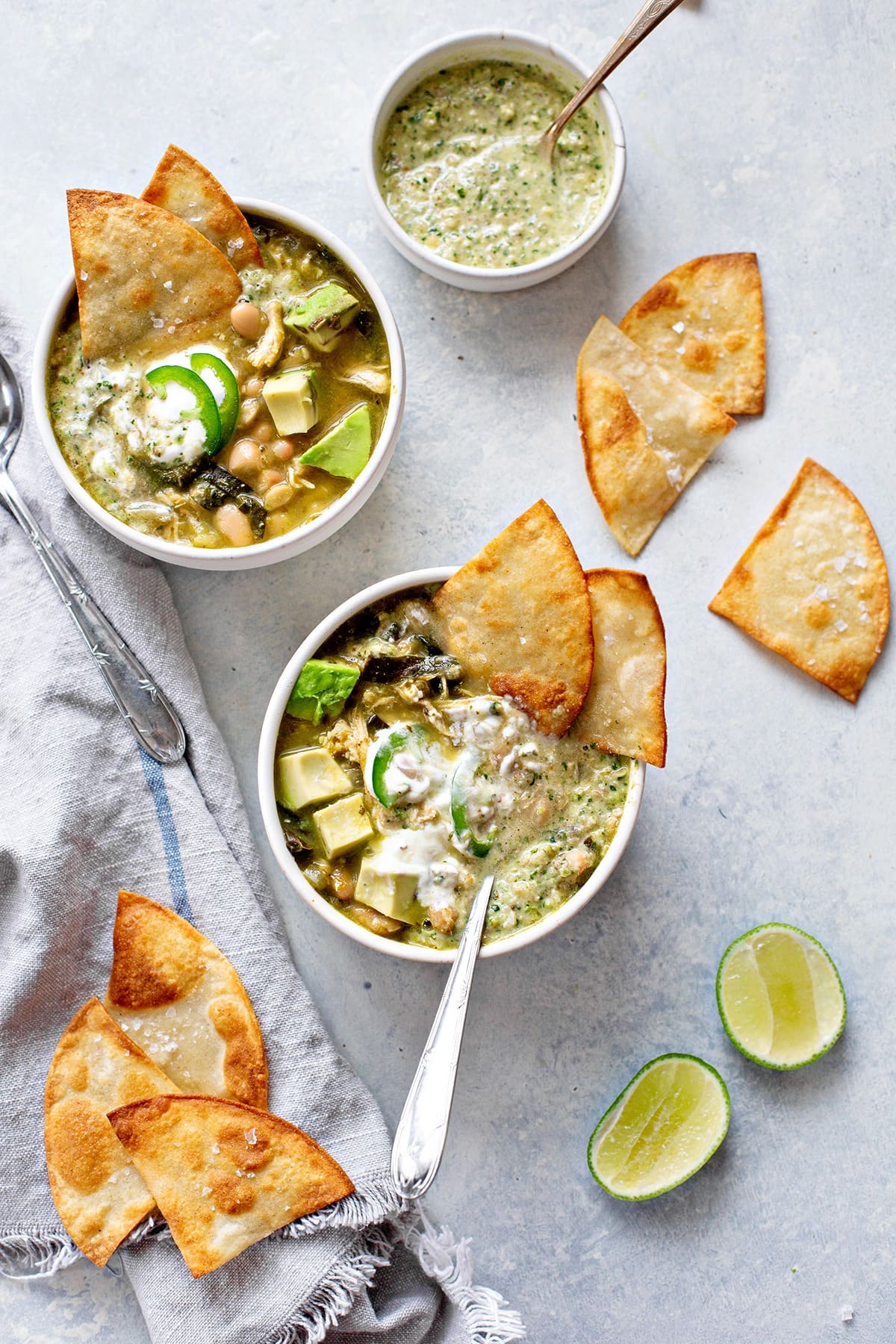 Chicken chili verde with white beans served on a bowl with feta bread. 