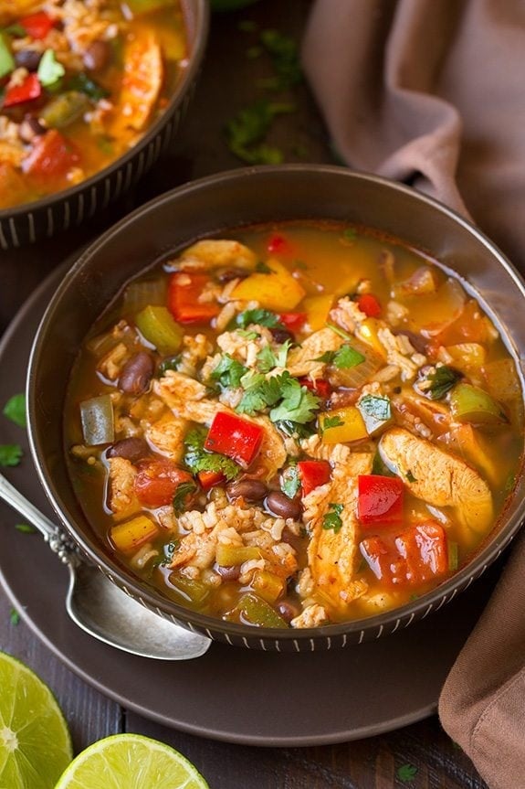 Chicken fajita soup in a bowl with shredded chicken, beans, peppers, and mouth-watering broth.. 