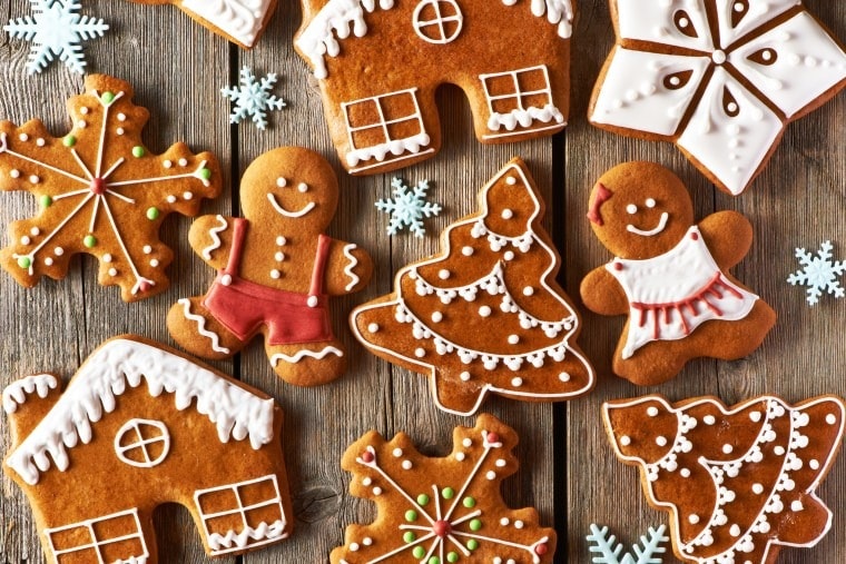 Festive gingerbread cookies on rustic wooden background