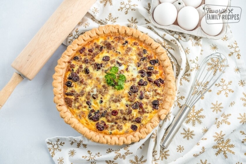 Top view of quiche filled with fluffy eggs and loaded with chunks of sausage, cheese, and cranberries. 
