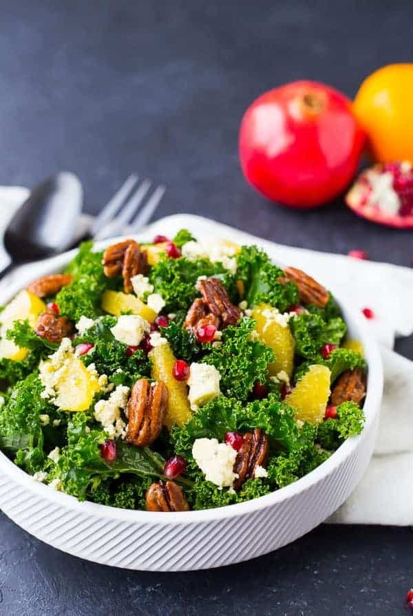 Christmas salad with kale, candied pecans, blue cheese, oranges, and pomegranate seeds.