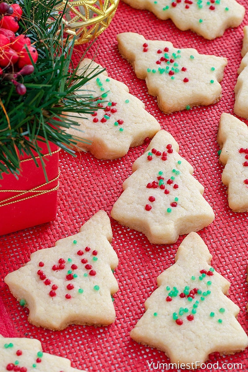 Christmas tree shaped shortbread cookies top with red and green sprinkles. 