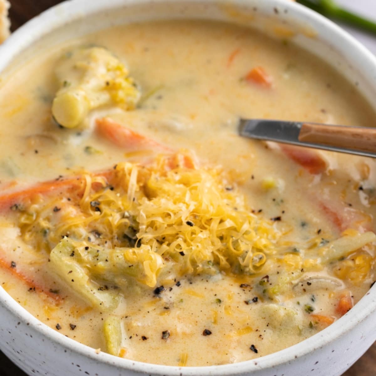 Creamy Panera Broccoli Cheddar Soup on a bowl garnished with grated cheese. 