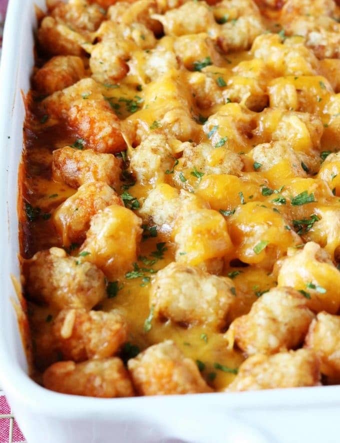 Cowboy casserole made with tater tots, ground beef, cheddar cheese and sour cream.