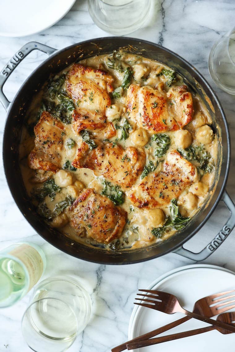 Creamy chicken and gnocchi cooked in a skillet. 