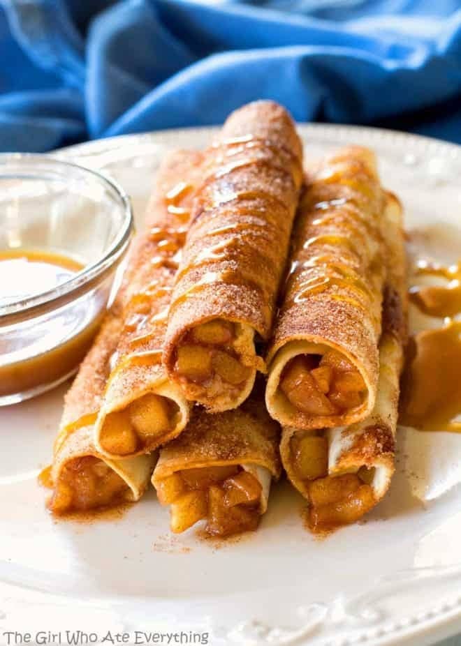 Creamy caramel apple taquitos drizzled with caramel and cinnamon powder. 