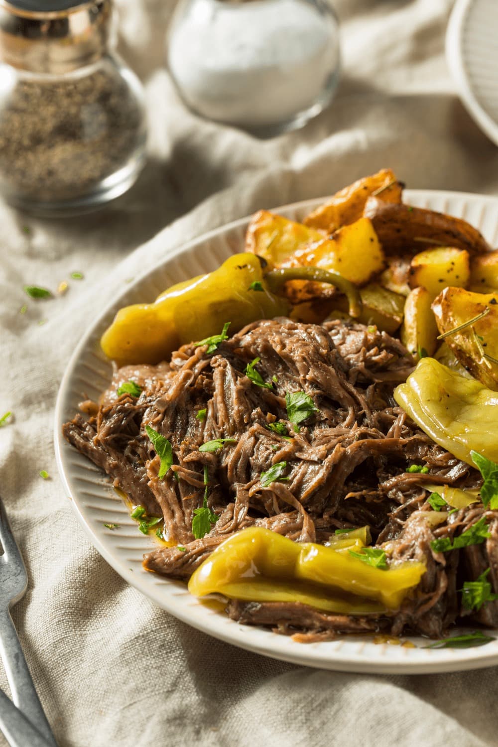 Crock Pot Mississippi Pot Roast with pepperoncini peppers and potato wedges