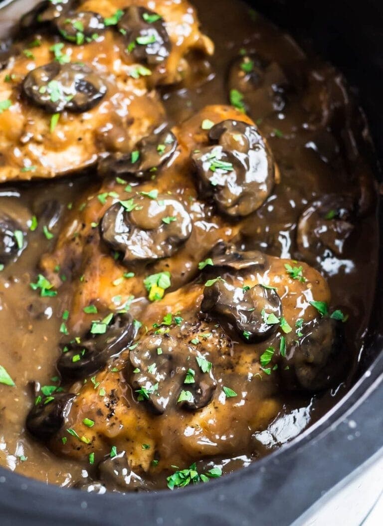 Crockpot Chicken Marsala with sliced mushrooms and garnished with chopped parsley