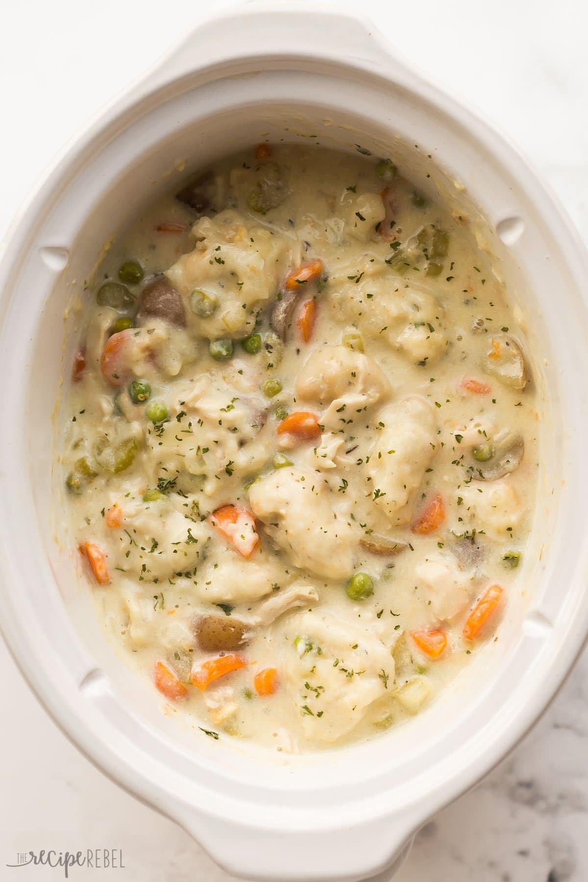 Crockpot Chicken and Dumplings garnished with chopped parsley