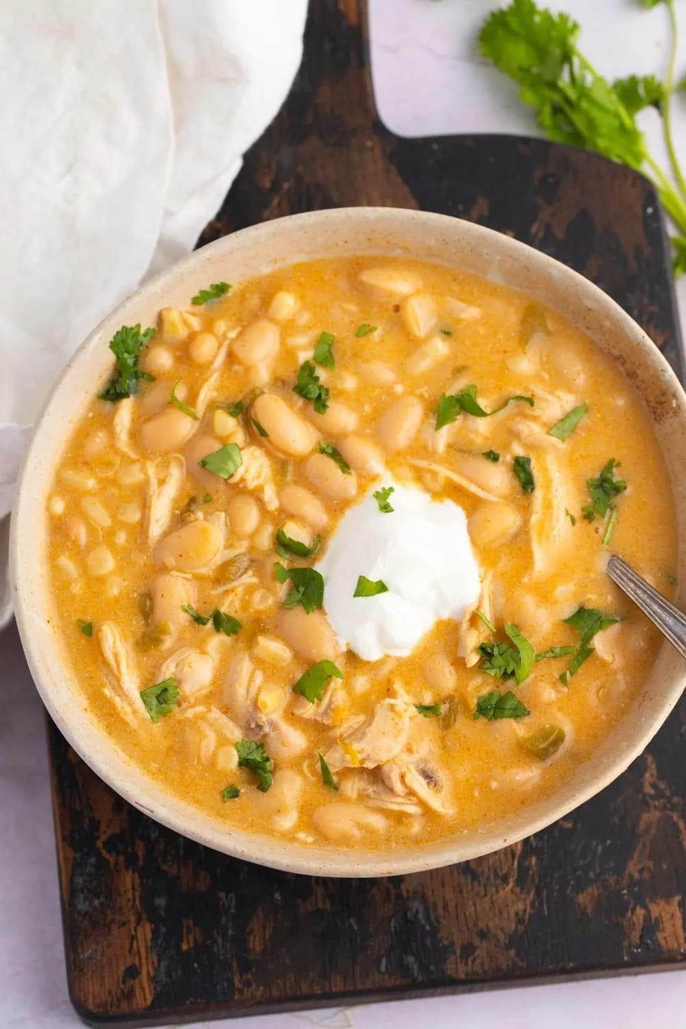 Crockpot White Chicken Chili with Sour Cream and Herbs in a Bowl
