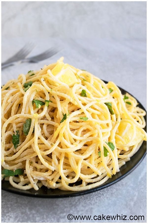 Lemon garlic pasta with cream and parmesan on a plate. 